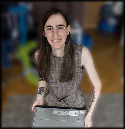 Jae holding a server, smiling and looking at the camera.